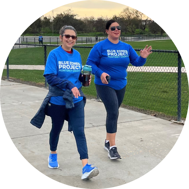 Two Women walking with Blue Zones project t-shirt